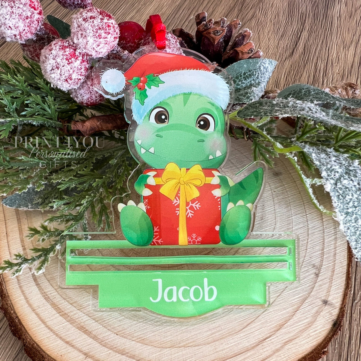 Personalised acrylic dinosaur Christmas money holder decoration shown with the optional presentation gift box