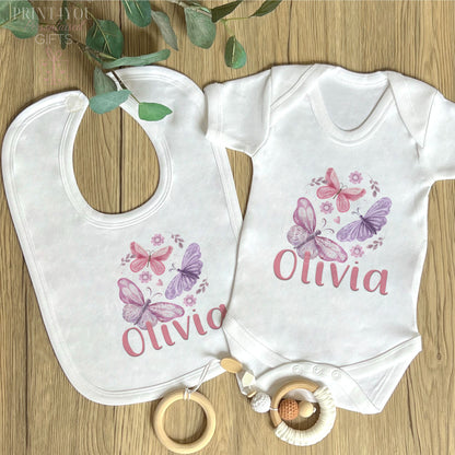 Personalised pink and purple butterfly vest for a new baby, printed with baby's name on soft white cotton.