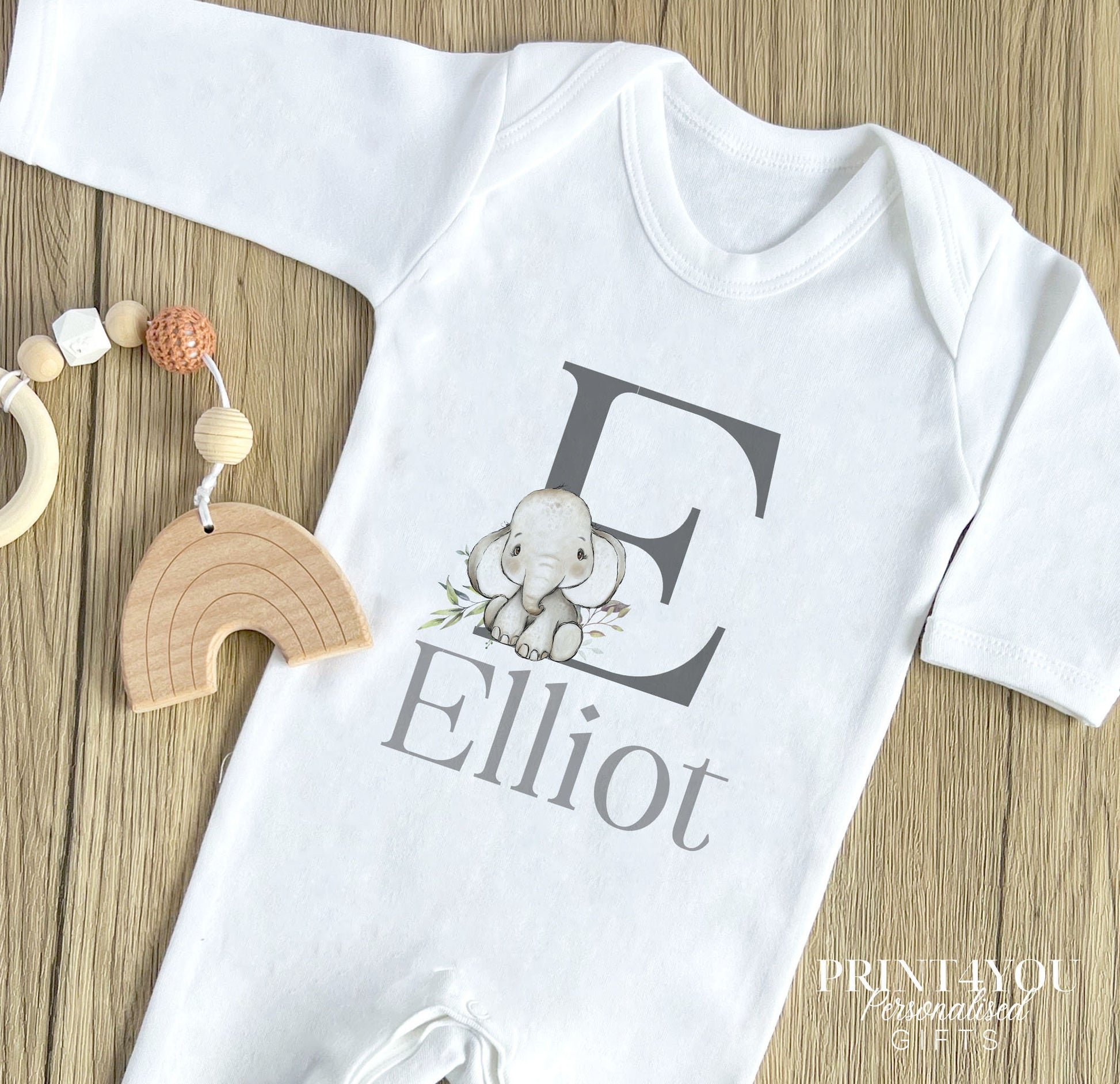 Personalised safari elephant alphabet bodysuit and vest new baby gift set, styled product photo.