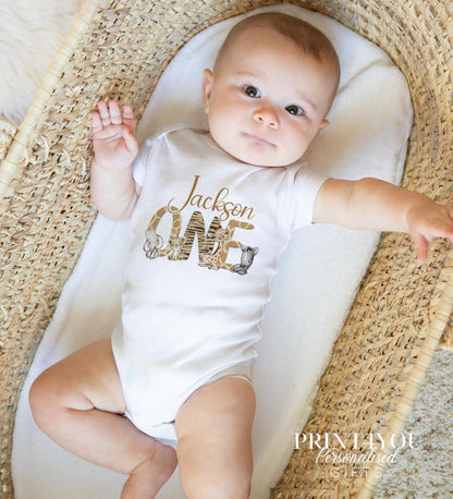 Personalised safari animal print first birthday outfit, styled for a cake smash photo shoot.
