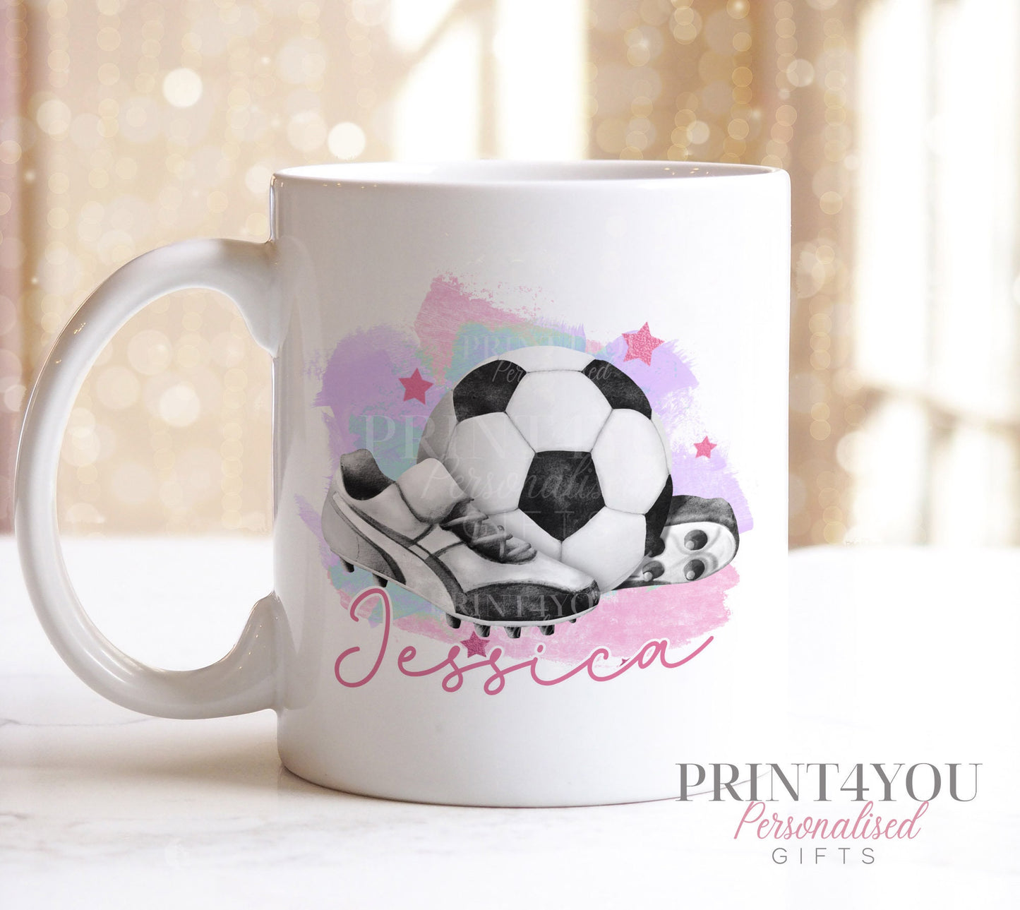 Side view of the pink handle football mug showing the personalised name printed beneath the boots design