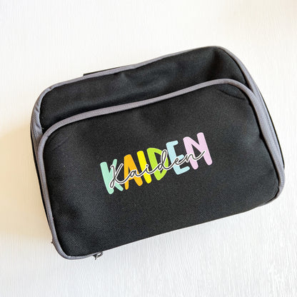 Personalised pink insulated rainbow lunch cooler bag with a name printed on the front.