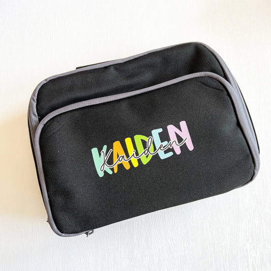 Personalised pink insulated rainbow lunch cooler bag with a name printed on the front.