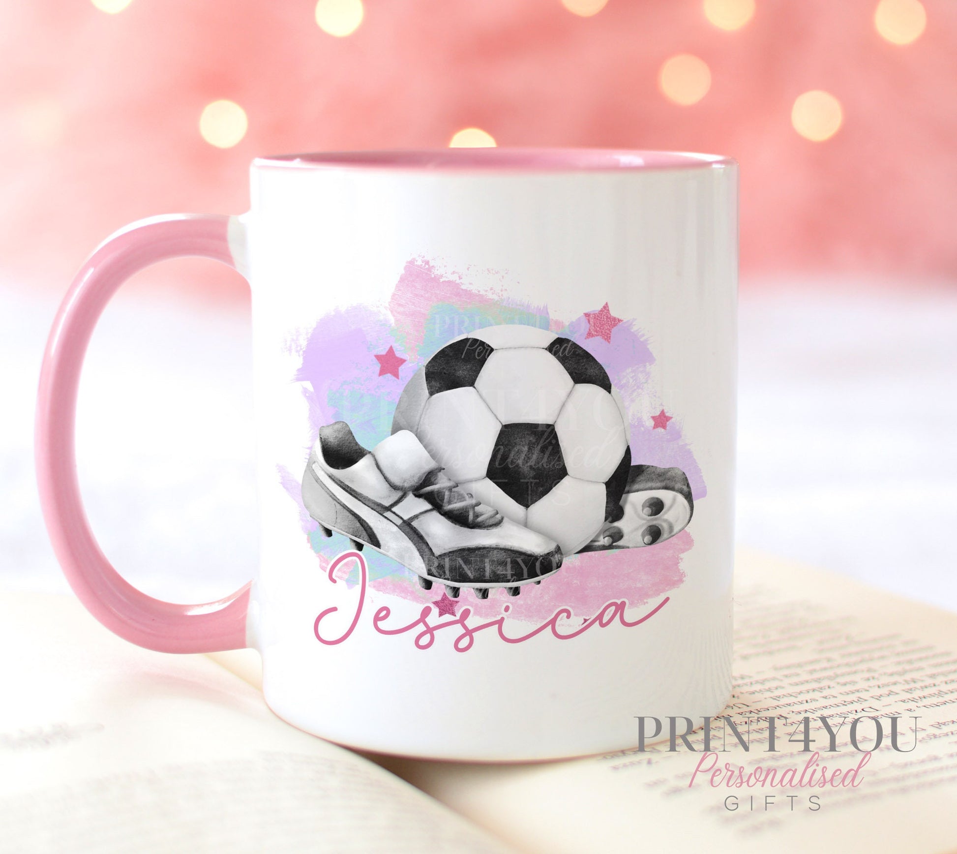 White ceramic mug with pink handle printed with a football and boots design and a personalised name