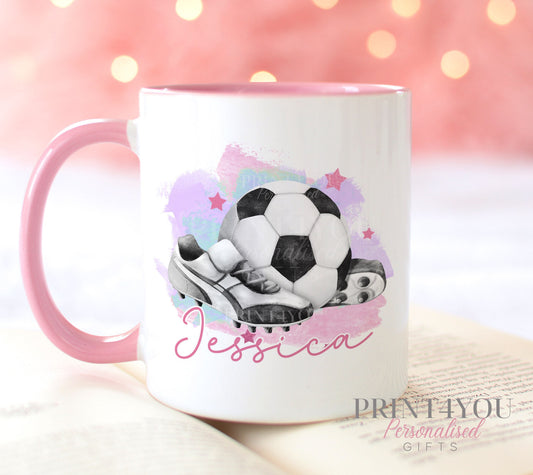White ceramic mug with pink handle printed with a football and boots design and a personalised name
