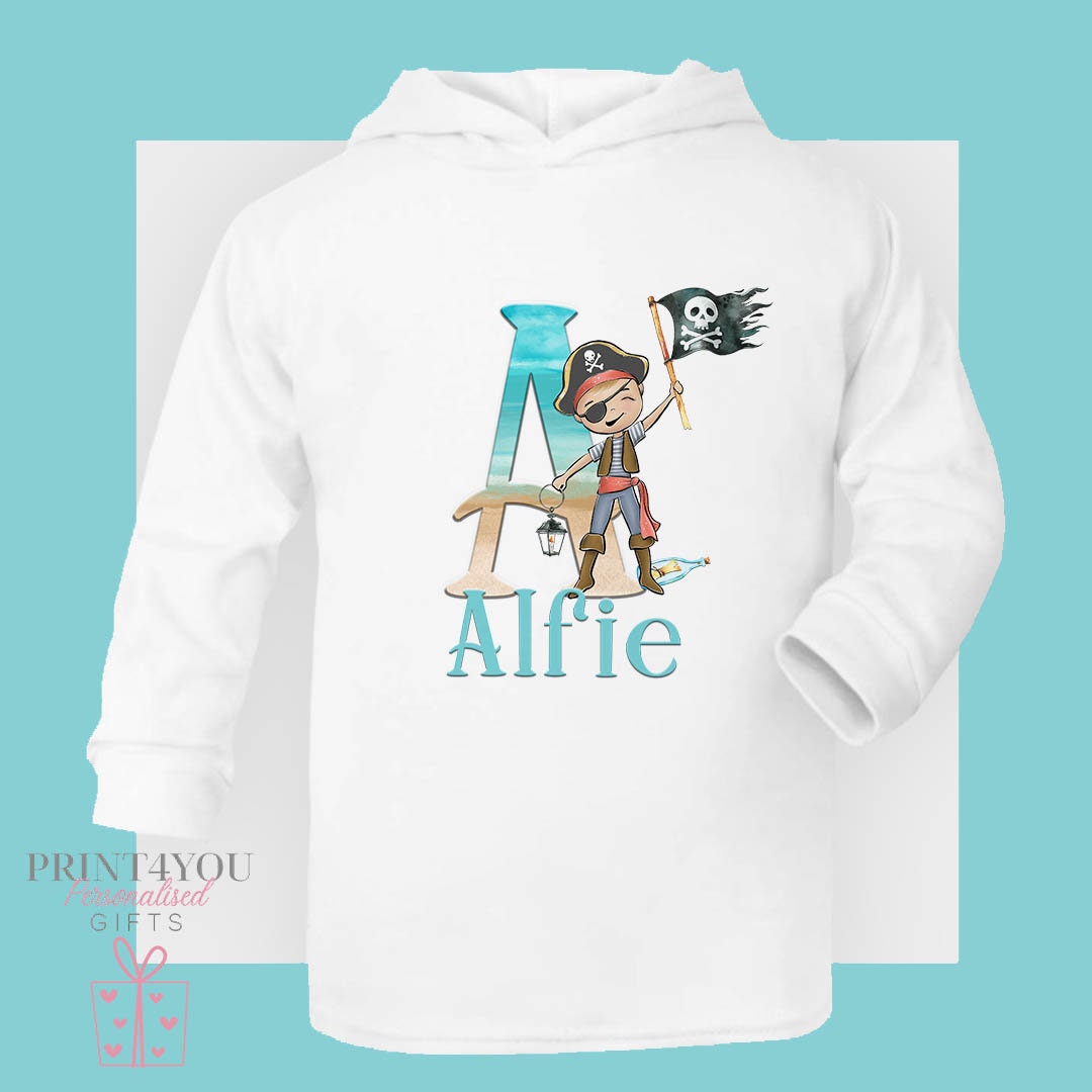 White hooded children's t-shirt printed with a pirate boy design, a beach-themed letter 'A' and the personalised name 'Alfie'