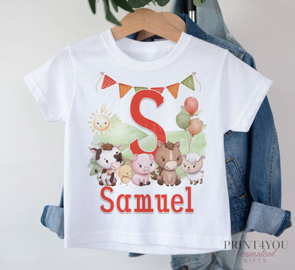 White children's t-shirt on a hanger, printed with a red letter S, bunting and farm animals, personalised with the name Samuel.