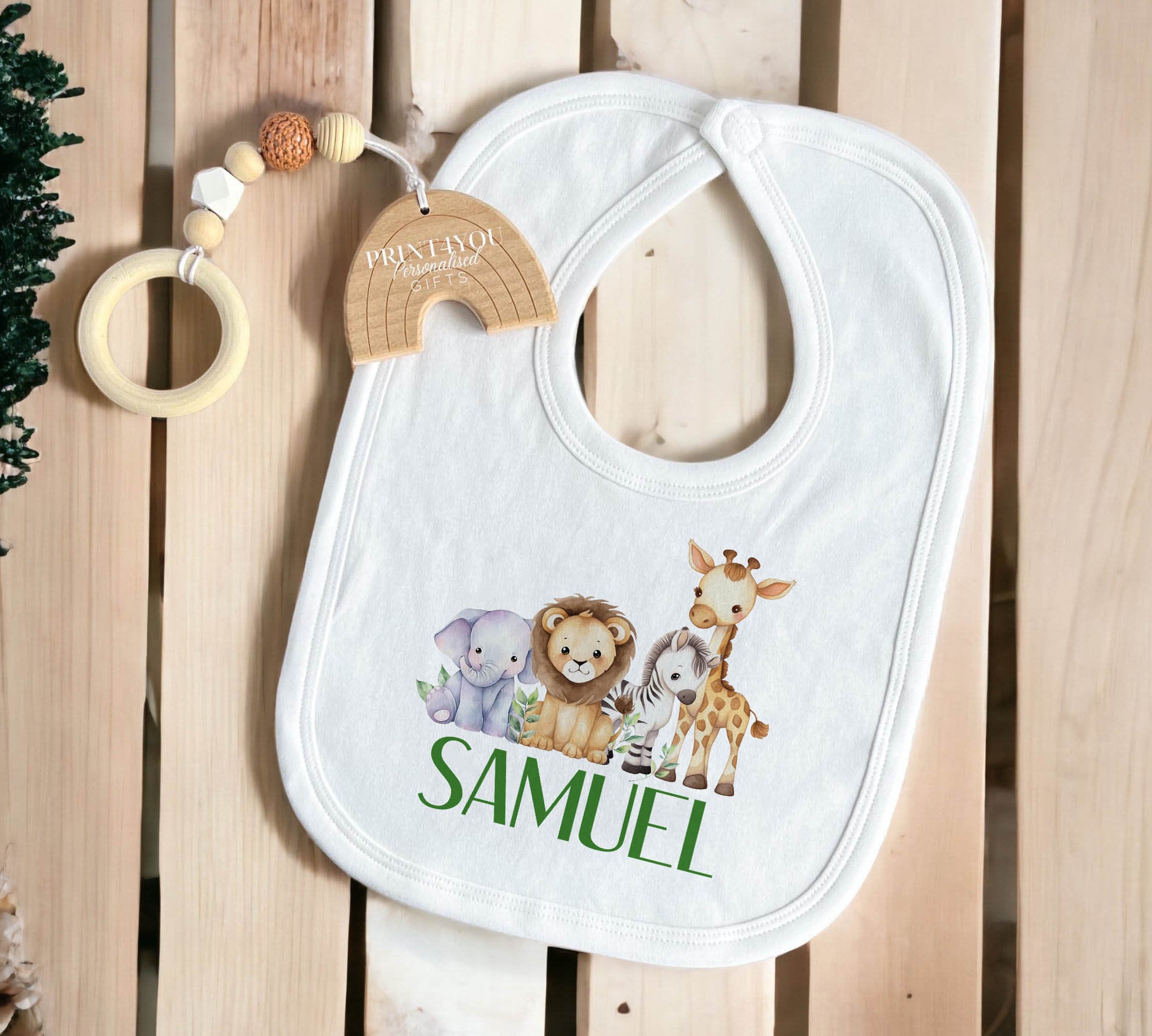 Baby wearing the personalised safari jungle animals sleepsuit from the new baby gift set.