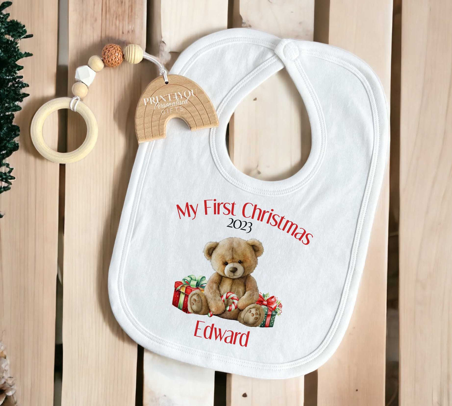 Personalised Baby's First Christmas vest with custom name and teddy bear design on white cotton.