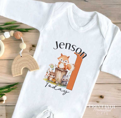 White baby vest featuring the Woodland Fox first birthday print and personalised name.