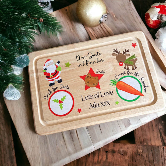 Personalised Santa treat wooden board laid out with cookies and a glass of milk for Christmas Eve