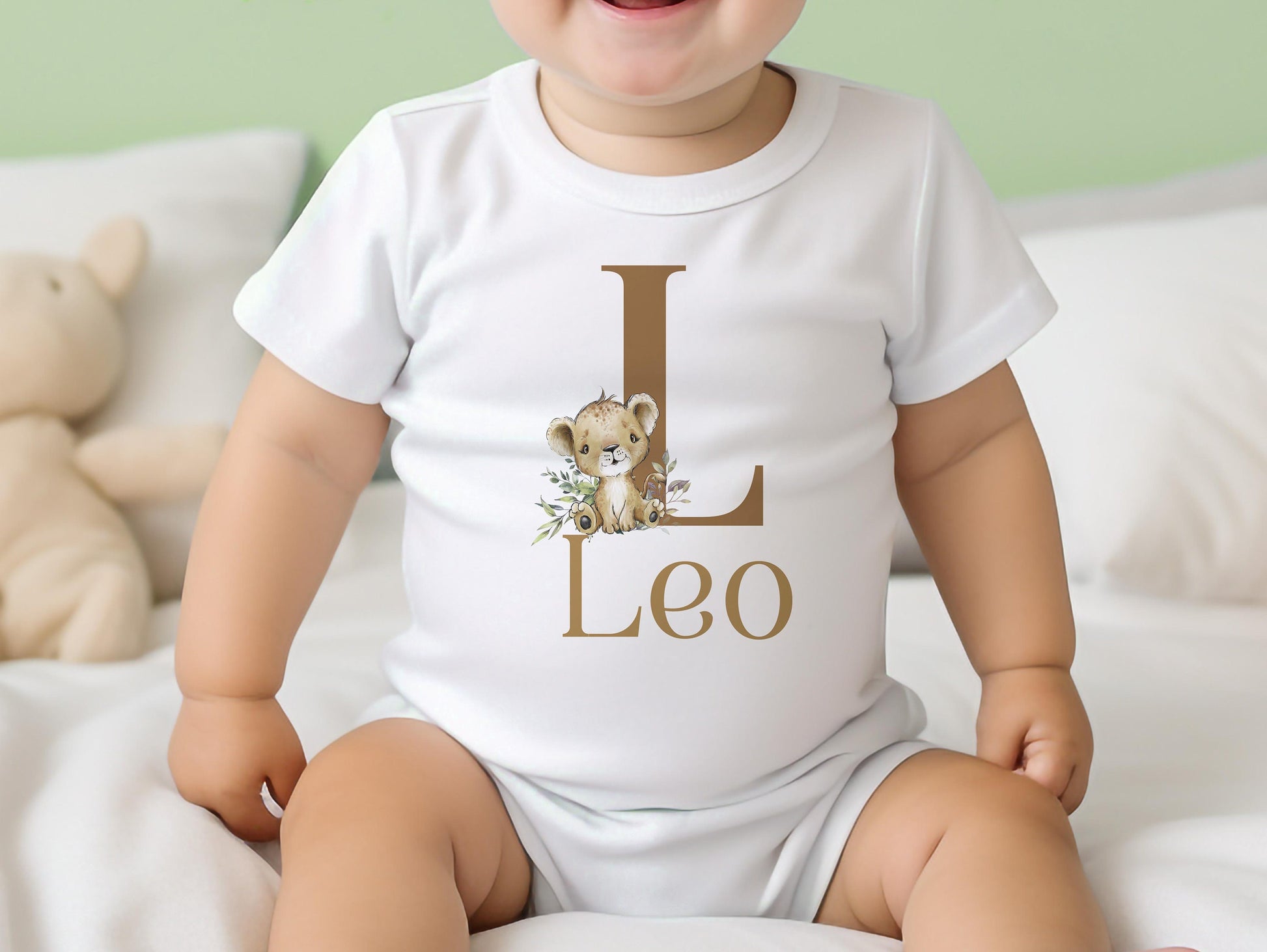 White cotton baby bib personalised with a lion design and the baby's name, for a new baby gift.