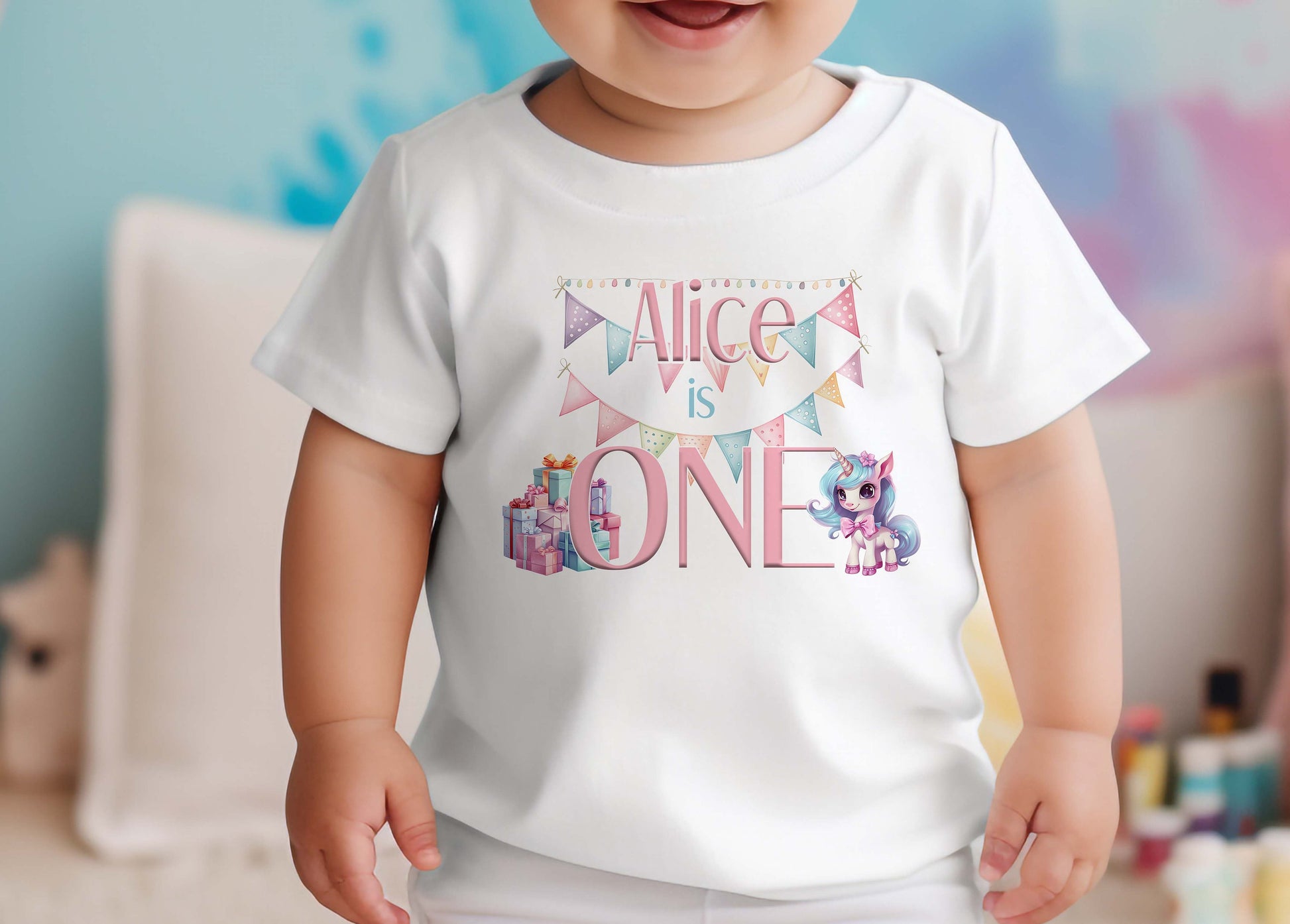 Personalised Unicorn first birthday bib in white cotton with custom name, number one and pastel unicorn print.