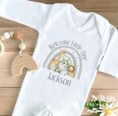 Baby wearing the personalised grey safari welcome baby sleepsuit.