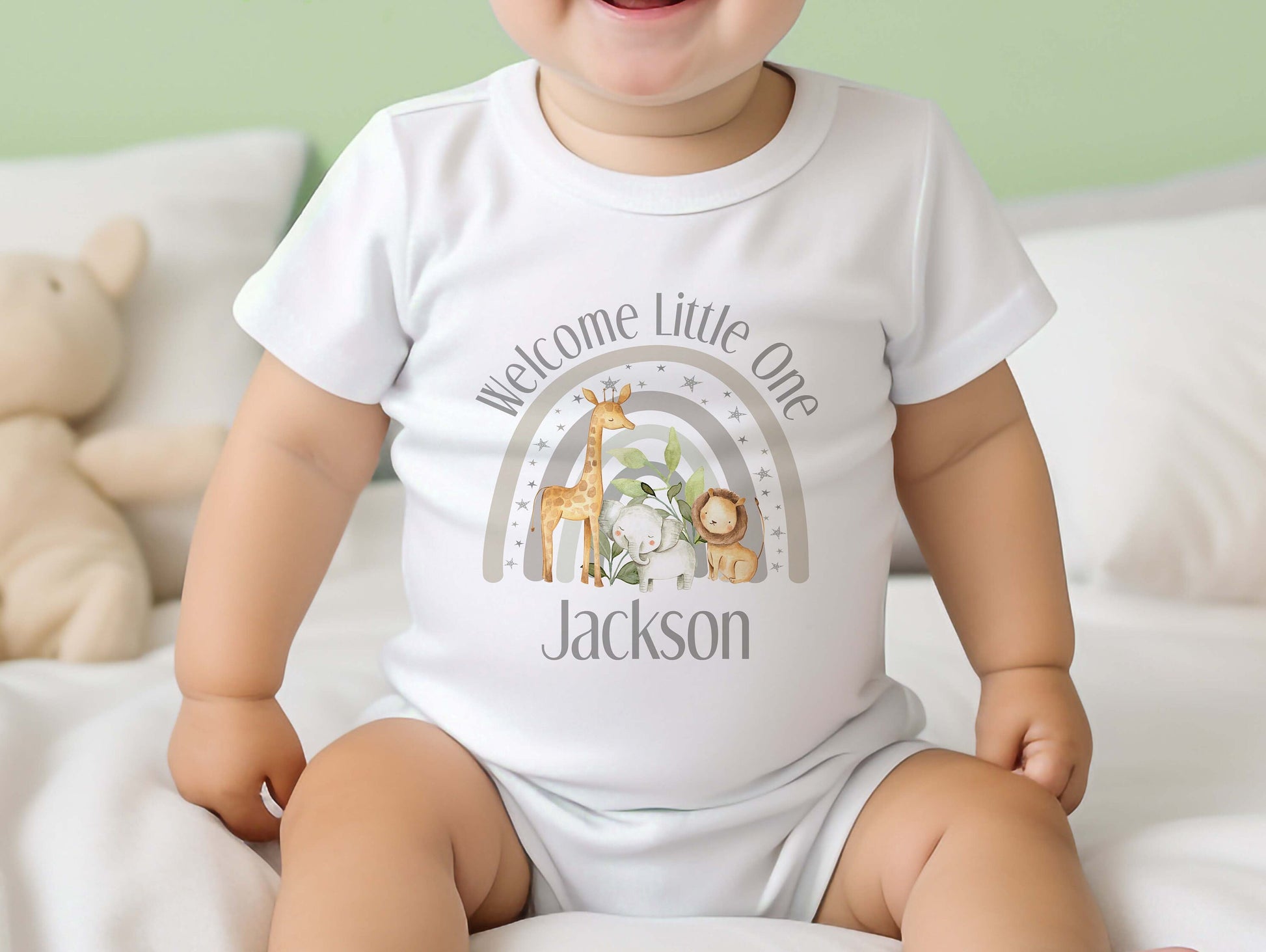 Personalised welcome baby grey safari gift set styled flat, showing vest, sleepsuit and bib.