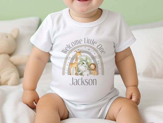 Personalised welcome baby grey safari gift set styled flat, showing vest, sleepsuit and bib.
