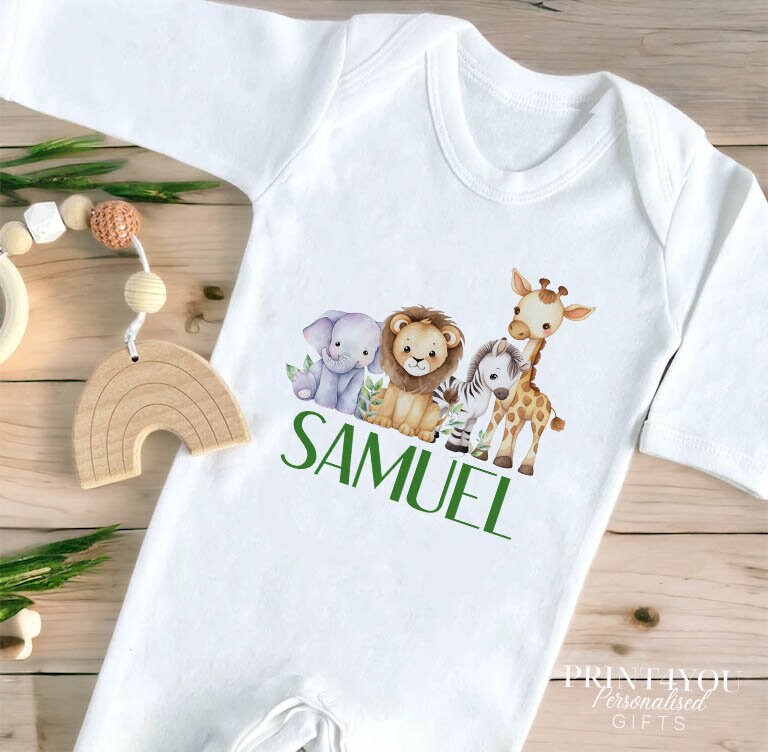 Close-up of the safari jungle animals print and personalised name on the baby vest.