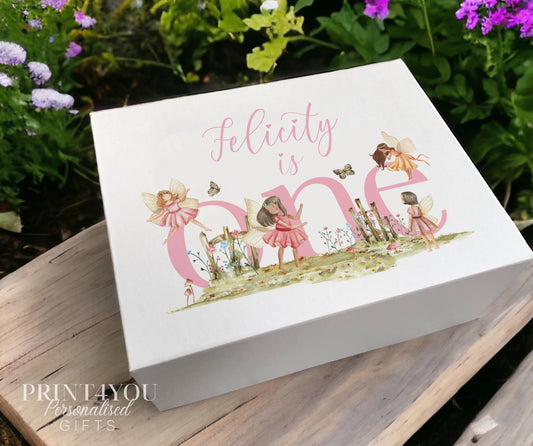 White sturdy card personalised keepsake box with magnetic closure, printed with a fairytale fairies meadow design and the words 'Felicity is one', Medium size.
