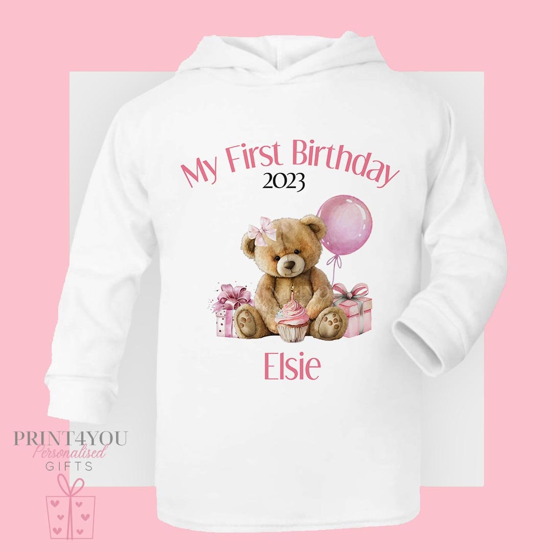 Personalised teddy bear first birthday hooded t-shirt in soft white cotton jersey with custom name, size 6-12 months.