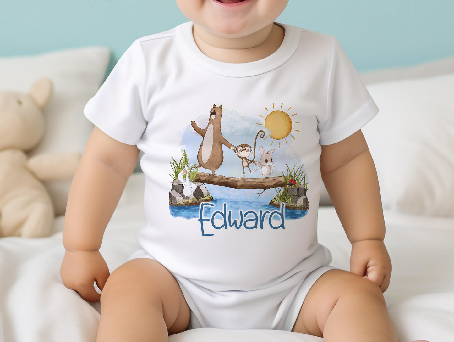 Personalised new baby bib printed with the animals on a log design and baby's name.