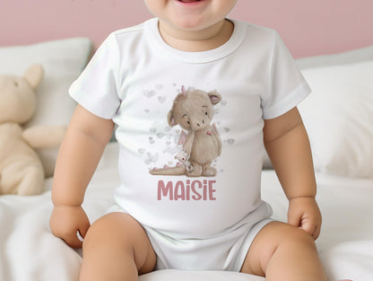 Personalised new baby bib printed with a pink baby dragon design and baby's name.