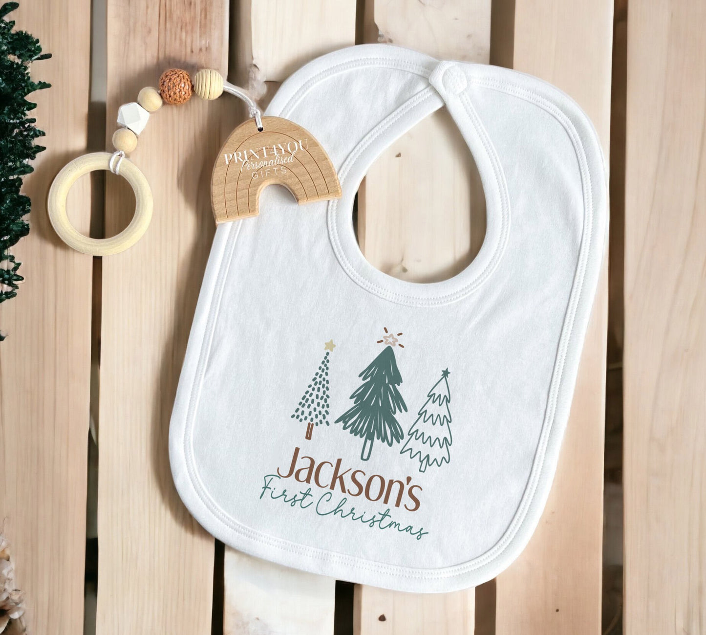 Personalised Christmas sleepsuit in soft white cotton, printed with baby's name.