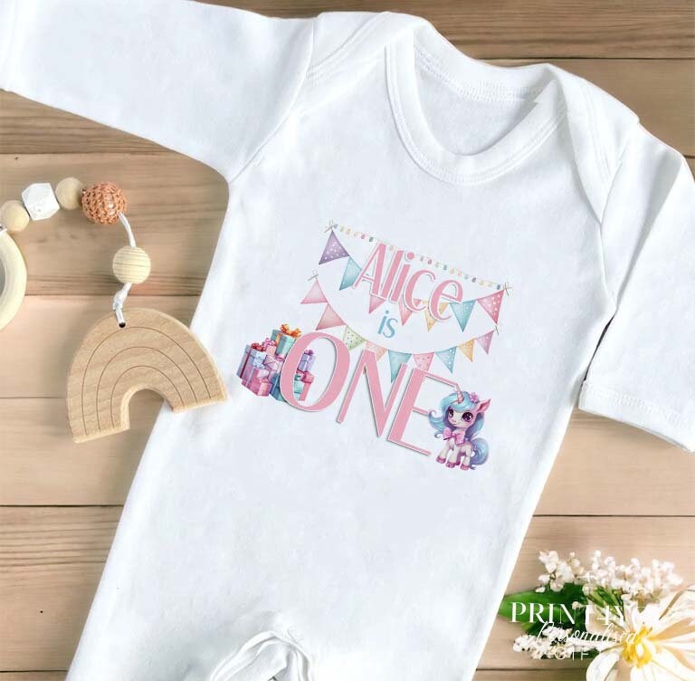 Personalised Unicorn first birthday vest in soft white cotton with custom name and number one print.