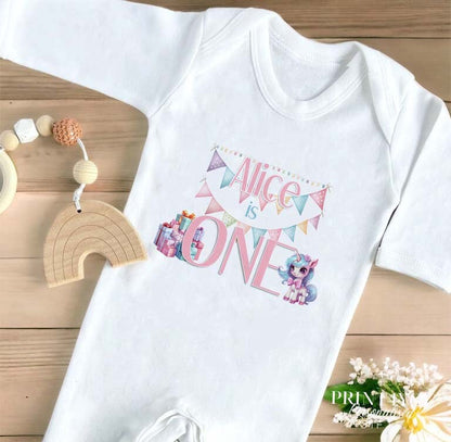Personalised Unicorn first birthday vest in soft white cotton with custom name and number one print.