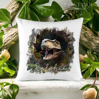 Velvet cushion cover printed with a roaring dinosaur bursting through a stone wall design and the name Ralphie.