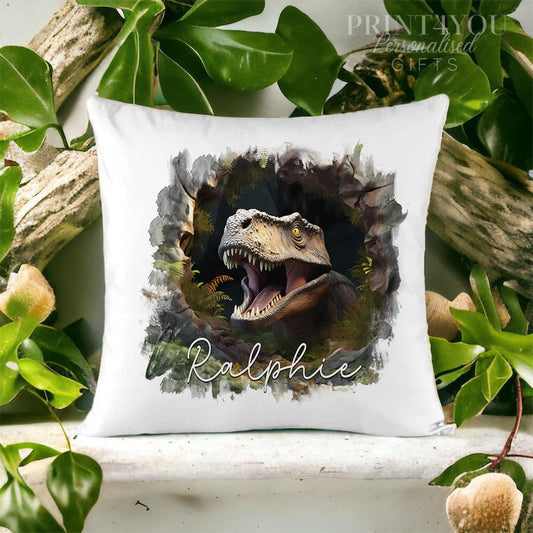 Velvet cushion cover printed with a roaring dinosaur bursting through a stone wall design and the name Ralphie.