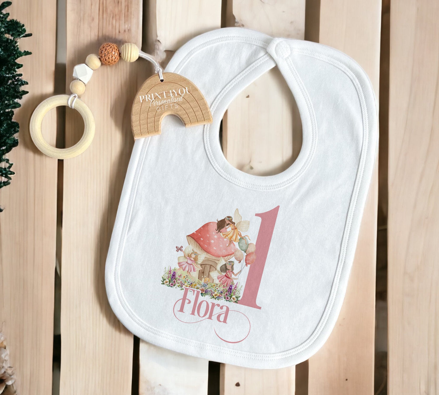 Close-up of the fairy print and personalised name on the first birthday outfit.