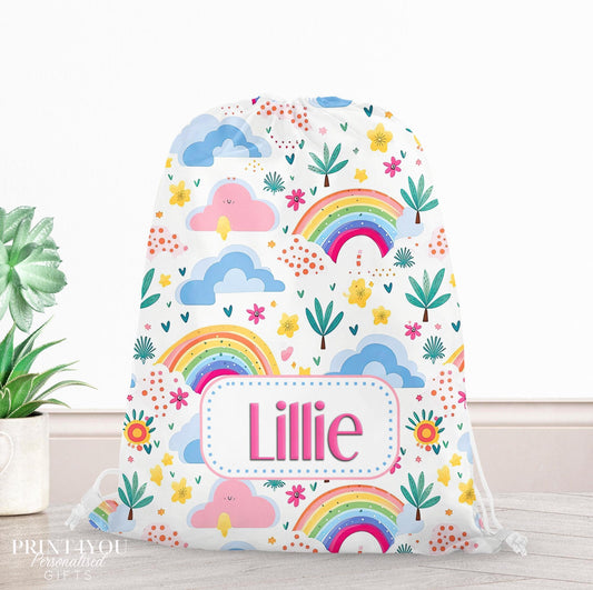 Cream drawstring PE bag printed with a colourful rainbow and clouds design, personalised with a child's name across the front