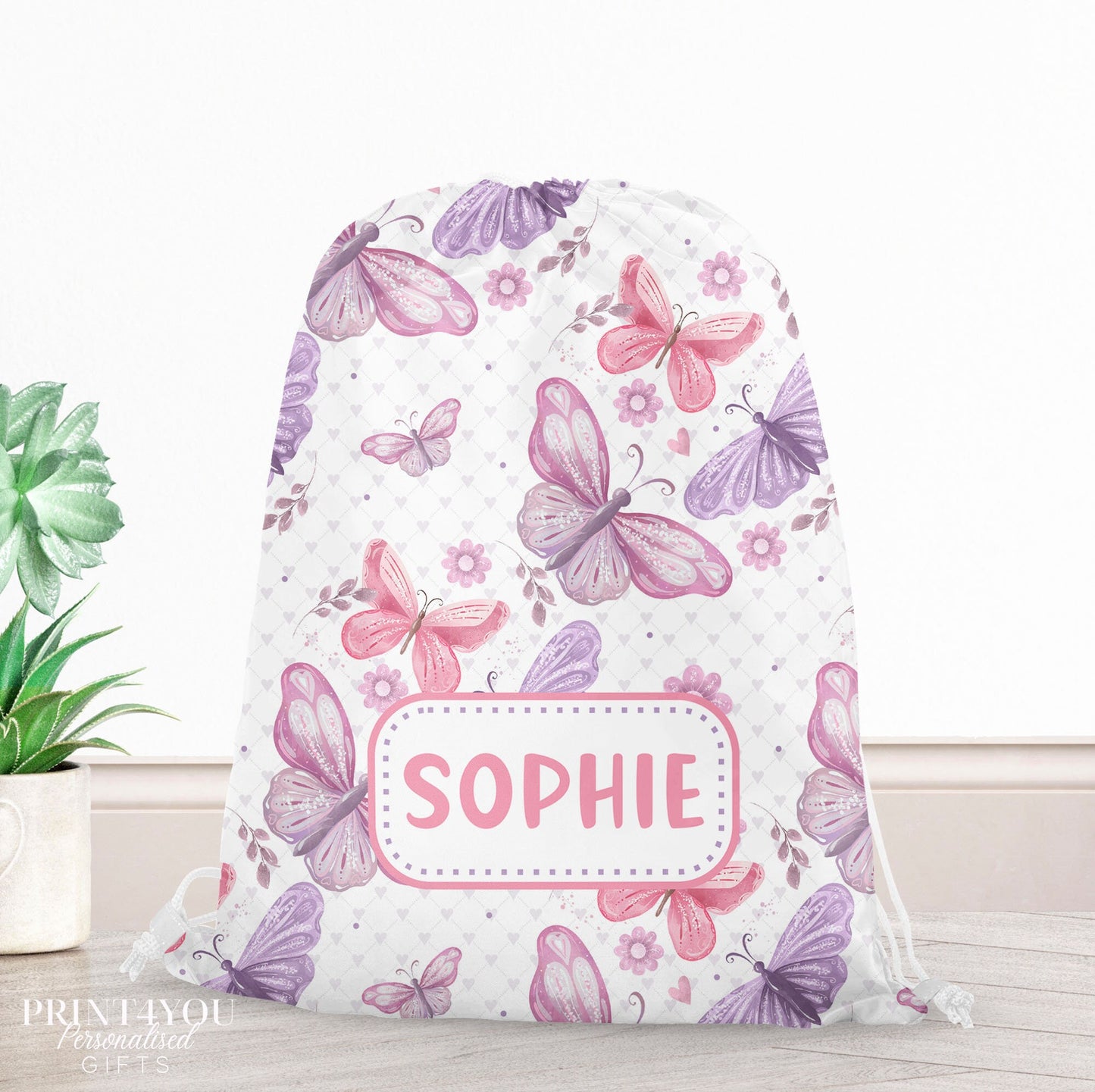 Personalised butterfly print drawstring PE bag with a child's name printed on the front, colourful butterfly design