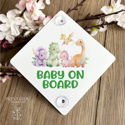 Baby on board car window sign attached with suction cups, dinosaur design