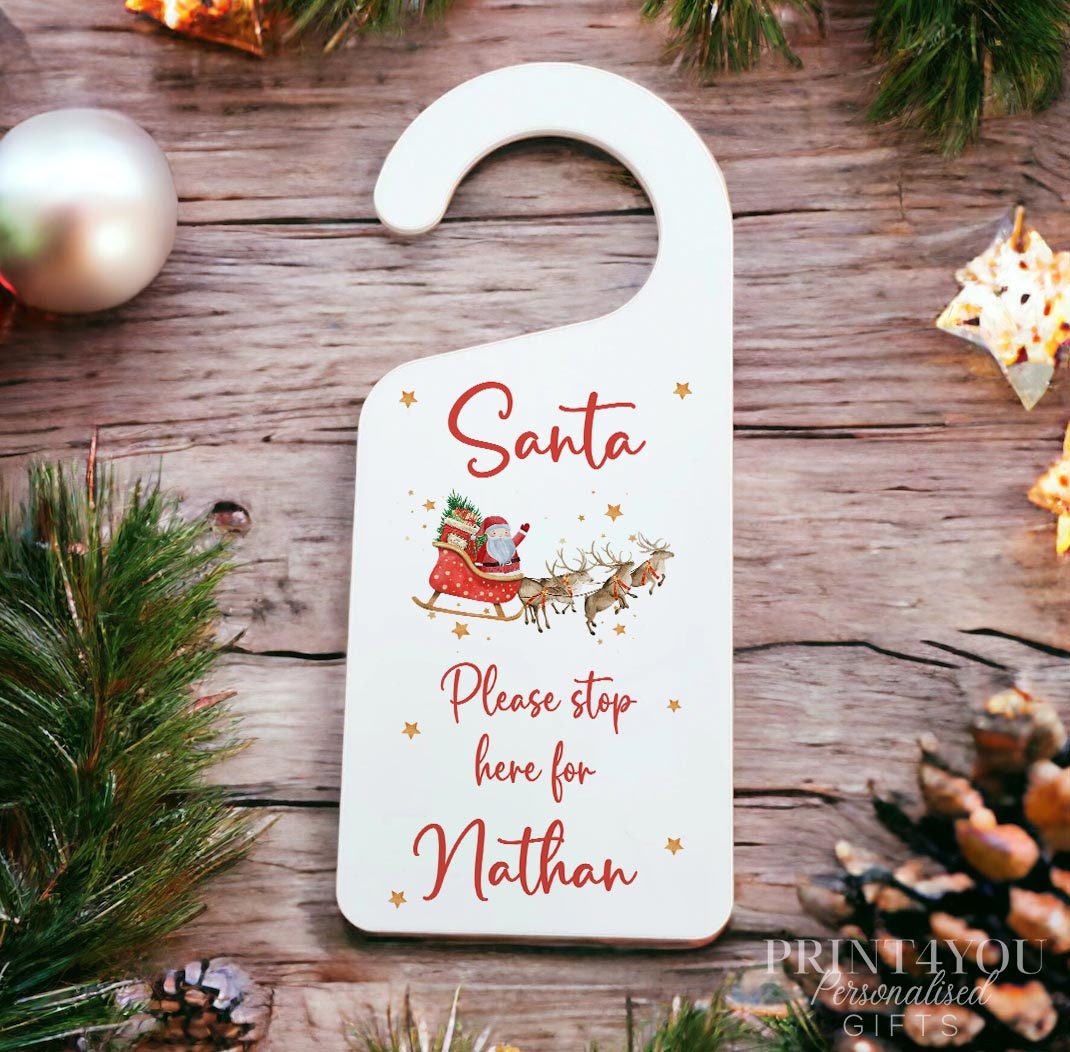 Personalised white acrylic Santa Stop Here door hanger with custom name, 23cm x 9cm
