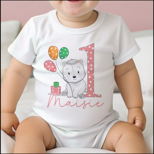 Personalised pink polar bear first birthday bib with the baby's name printed on the front.