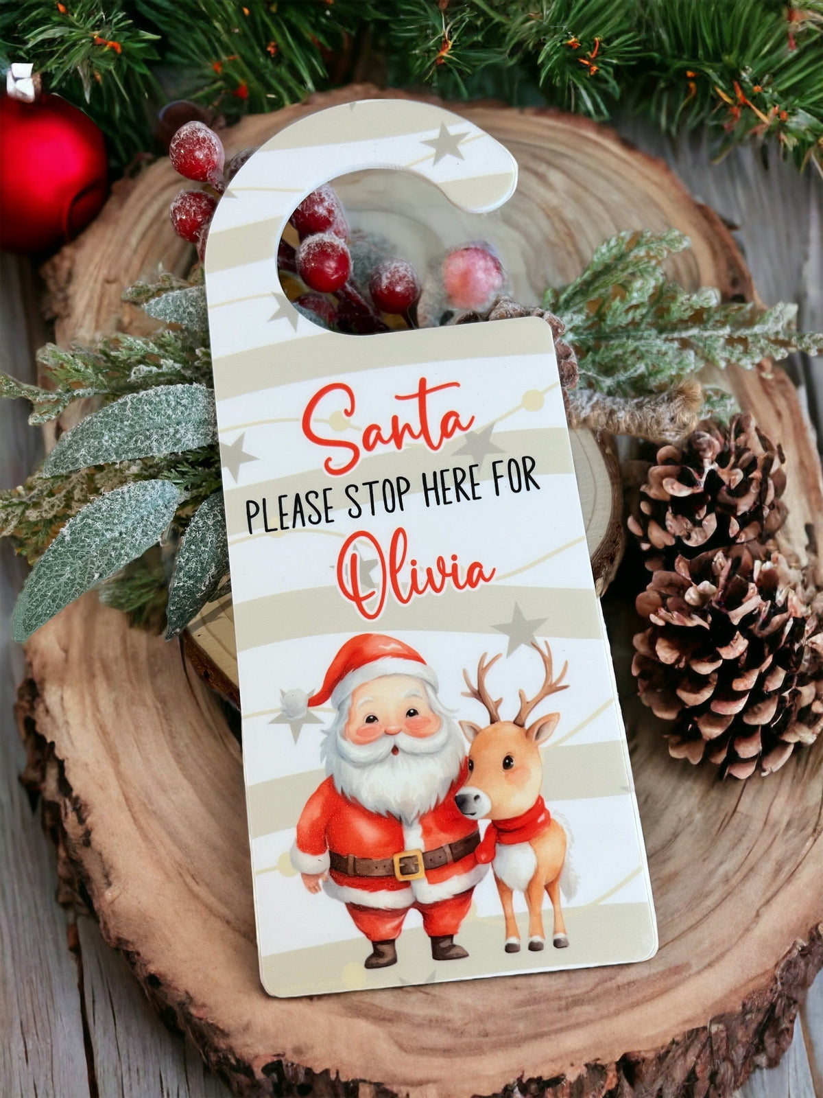 Personalised Santa and reindeer Stop Here acrylic sign hanging on a front door