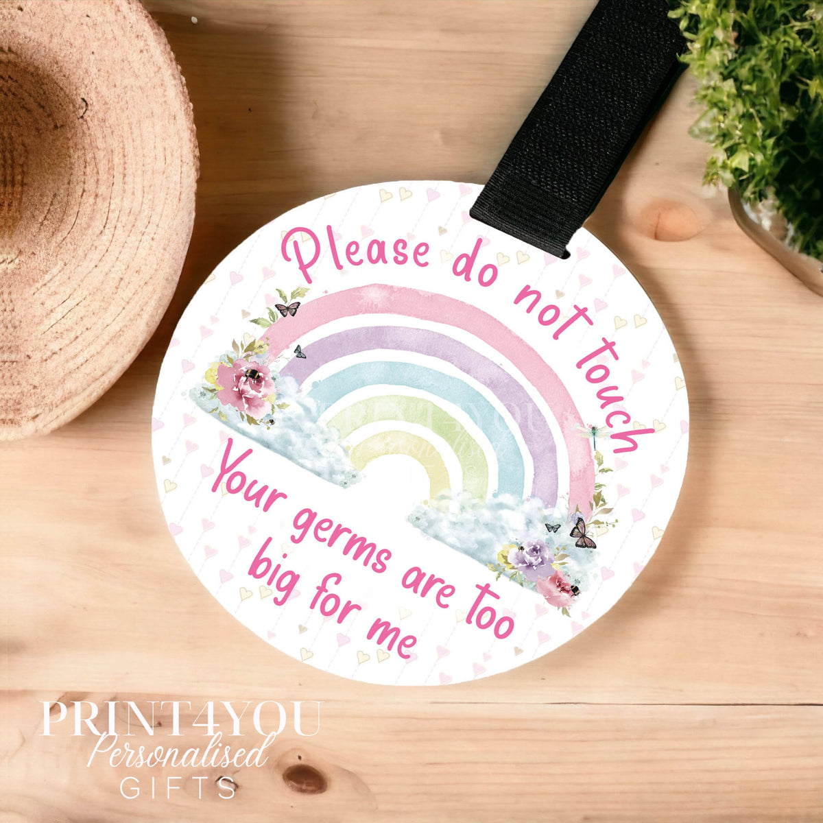 Pretty rainbow pram tag with black Velcro strap and Do Not Touch safety message