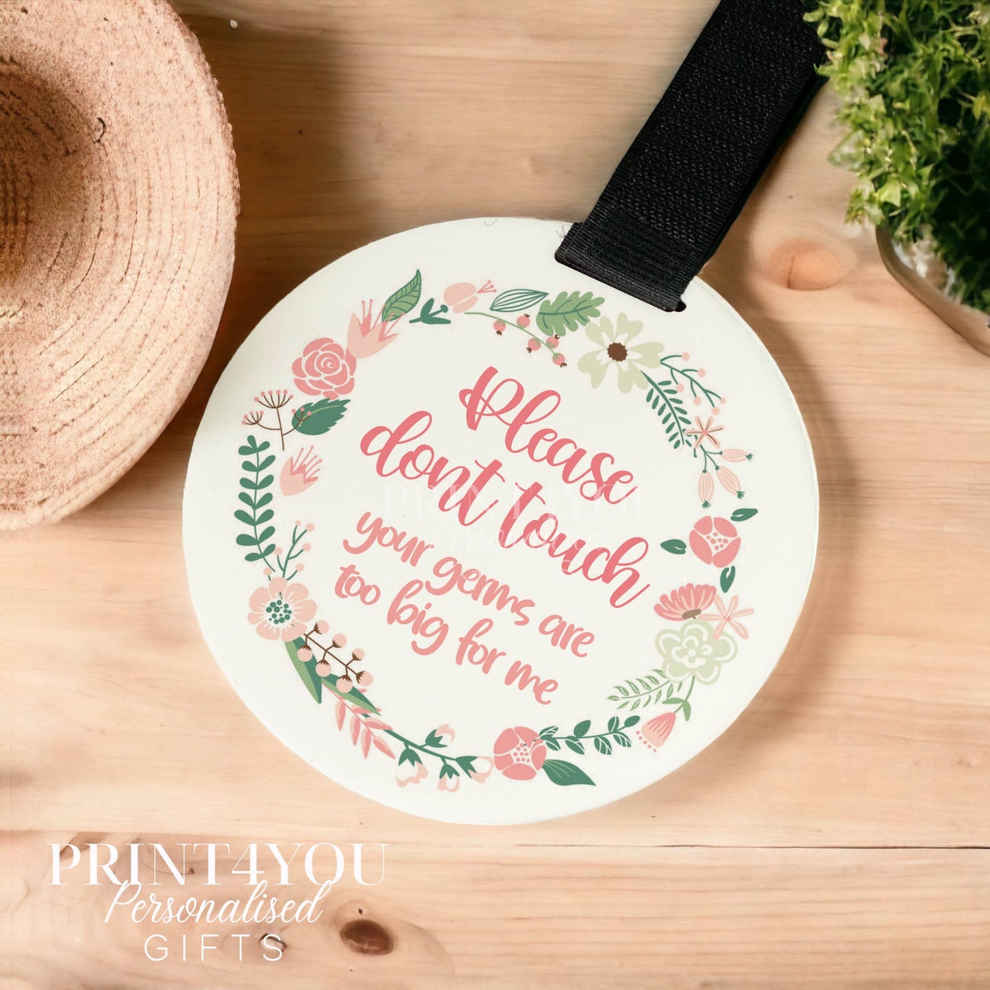 Pink floral baby handle sign reading please do not touch, hanging from a pram handle