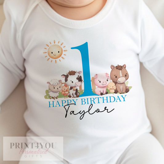 White cotton vest printed with a personalised blue farm animals first birthday design for baby boys.