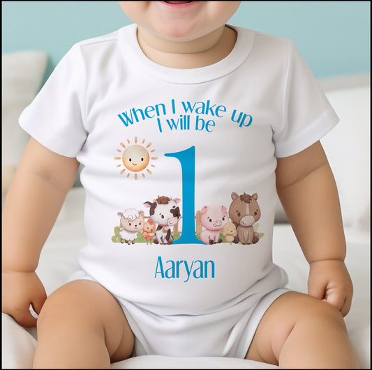 Personalised blue farm animals first birthday bib, printed with baby's name.