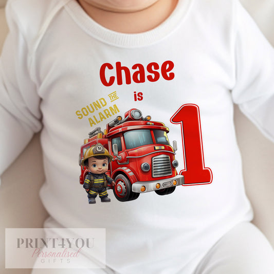 White personalised baby bib printed with the Fireman Engine first birthday design.