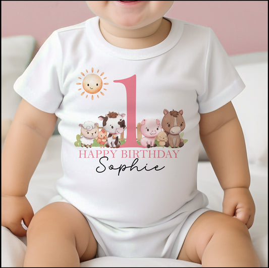 Bib in soft white cotton printed with the pink farm animals first birthday design.