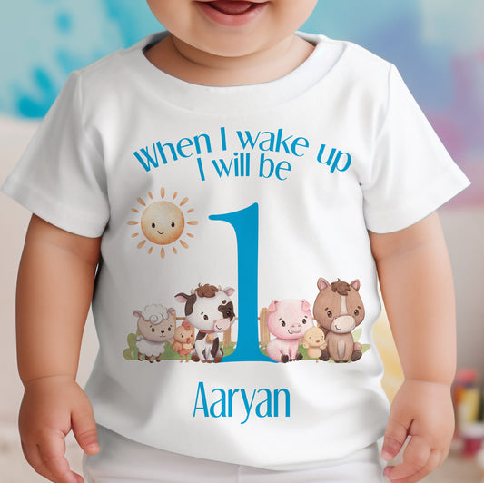 Personalised blue farm animals baby bib, printed with a custom name for a first birthday.