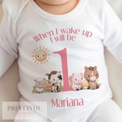Close-up of the pink farm animals print and personalised name on the first birthday vest.