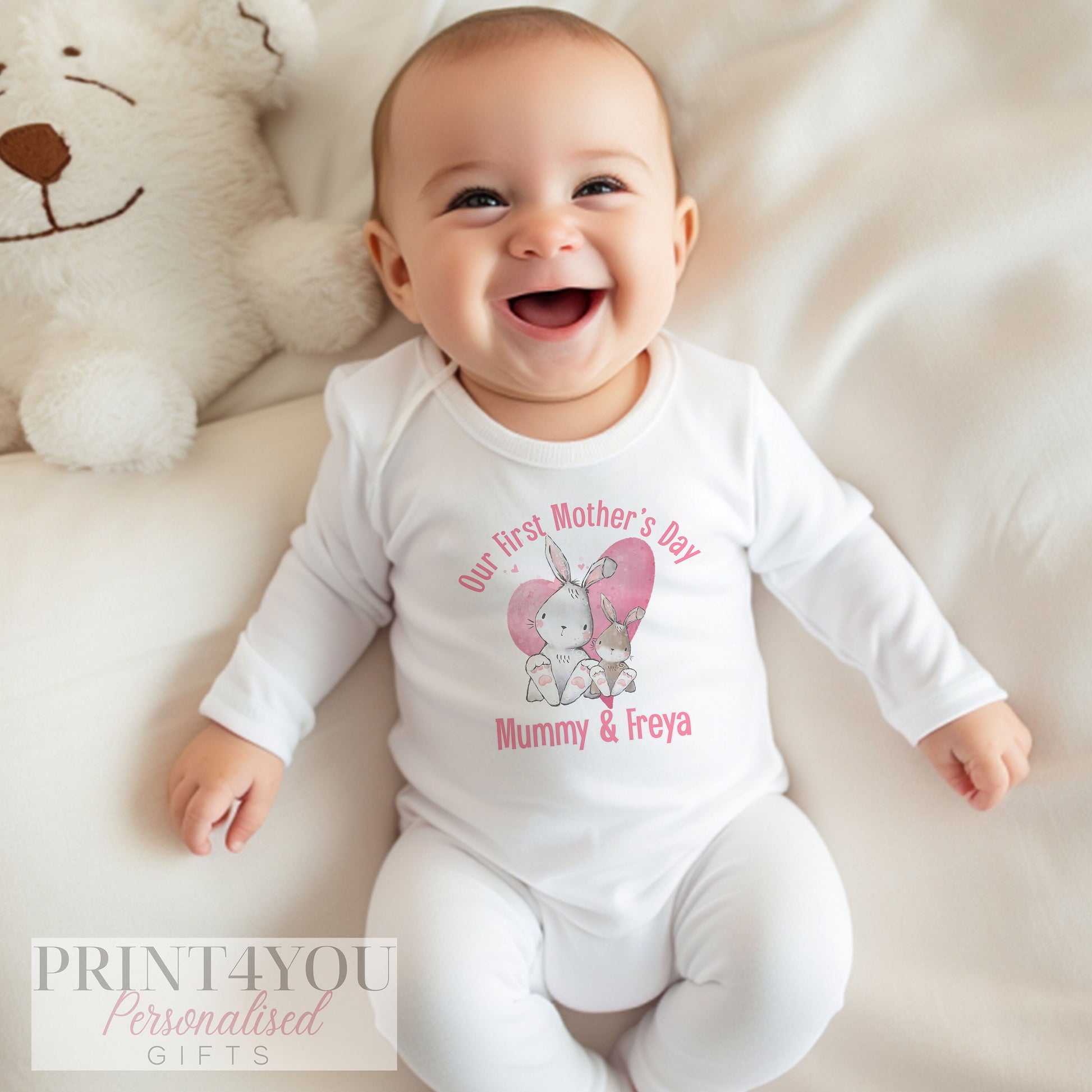 Personalised first Mother's Day baby sleepsuit in soft white cotton.