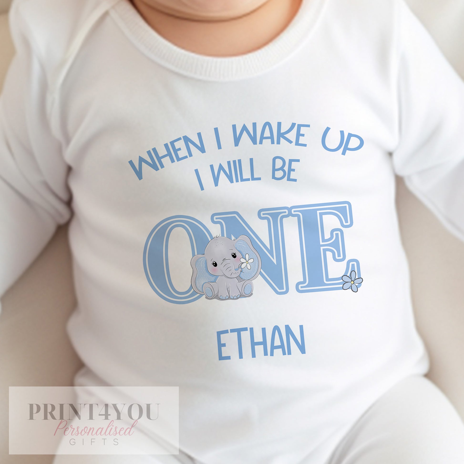 Bib in soft white cotton printed with a blue elephant design and personalised baby name.